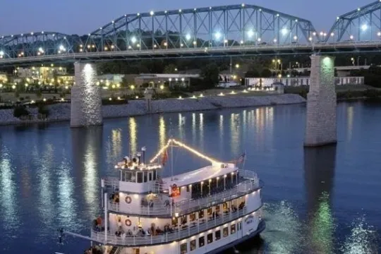 a train crossing a bridge over a body of water