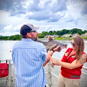 a man and a woman standing next to a body of water