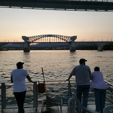 a group of people crossing a bridge over a body of water