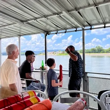 a group of people standing around a table